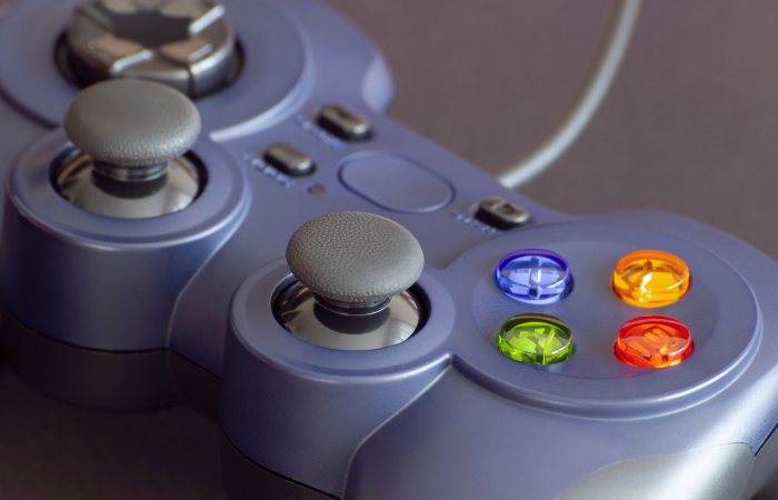 Detailed close-up of a gaming controller emphasizing its vibrant buttons.