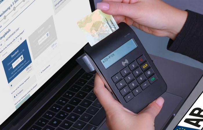 Close-up of a contactless payment using a card reader and laptop, highlighting digital security.