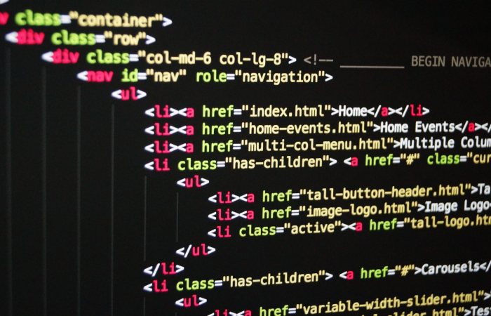 Close-up of vibrant HTML code displayed on a computer screen, showcasing web development and programming.