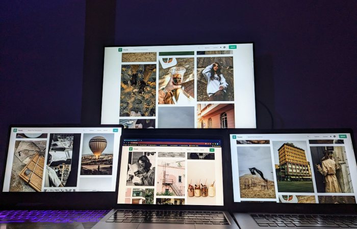 A modern digital setup with multiple screens showcasing diverse photographs, ideal for creatives.